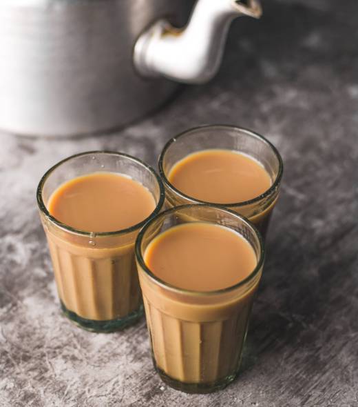 The Indian chai in glass cups with masalas to make the tea.